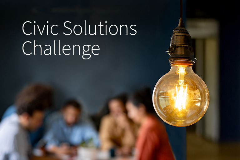 people around table with a light bulb in focus