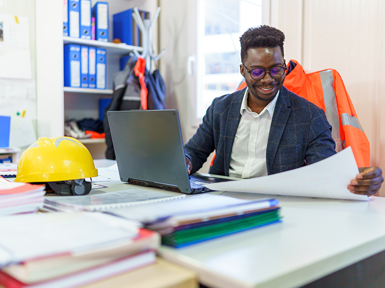 Man sitting behind computer in his office