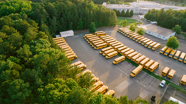 Parking lot filled with school buses
