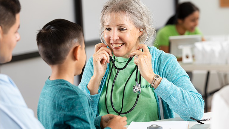 School nurse checking a child's heart rate 