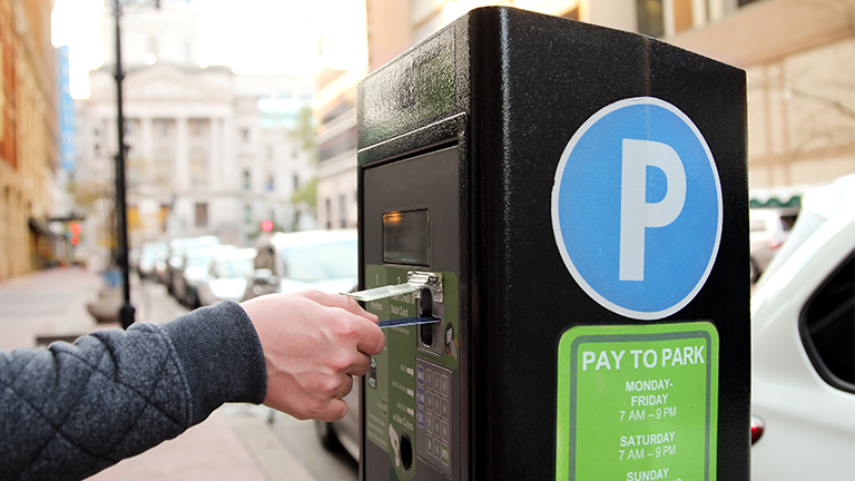 Man using a parking meter