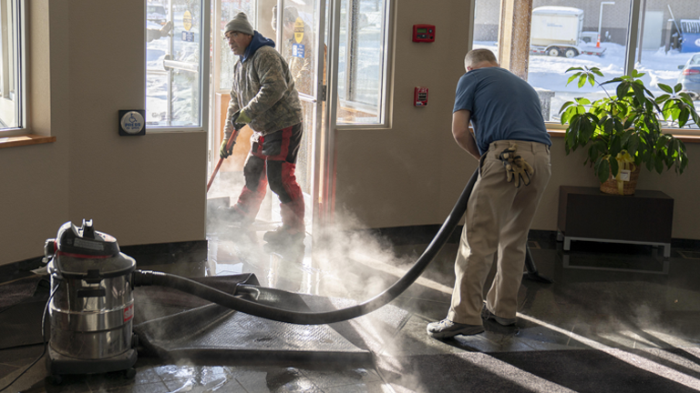 Facilities workers cleaning up after water damage