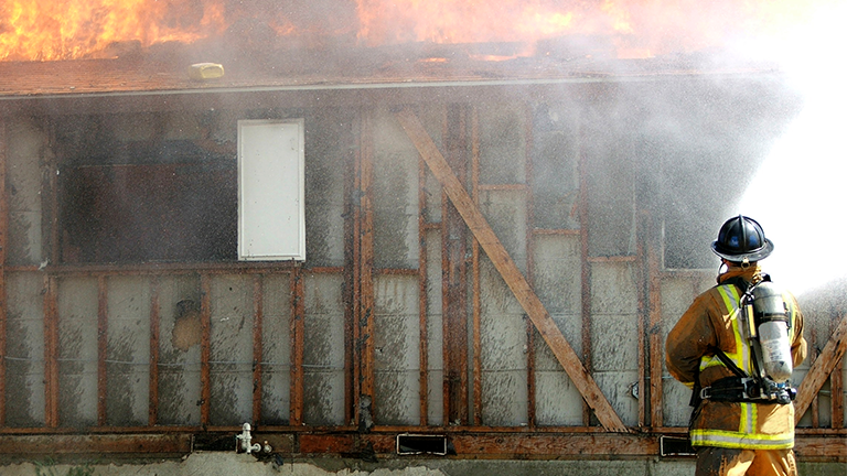 Fireman putting out fire