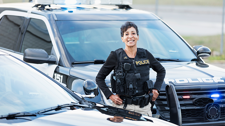 Police officer next to her squad car