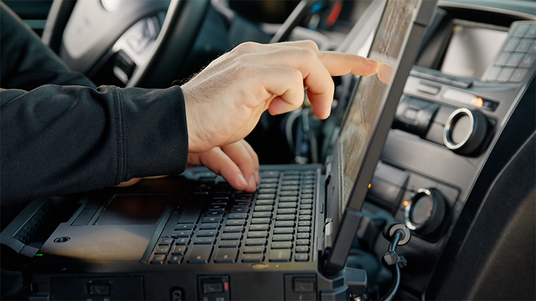 Police officer using his computer
