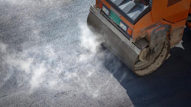 Road paver working on street