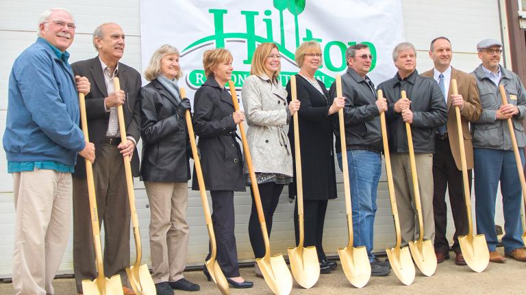 a group of community leaders with golden shovels at an official groundbreaking ceremony
