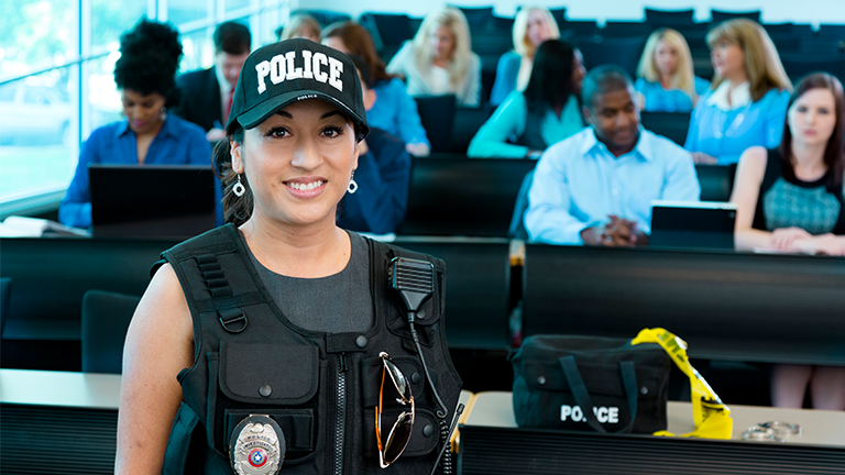 Police officer in a training simulation smiling